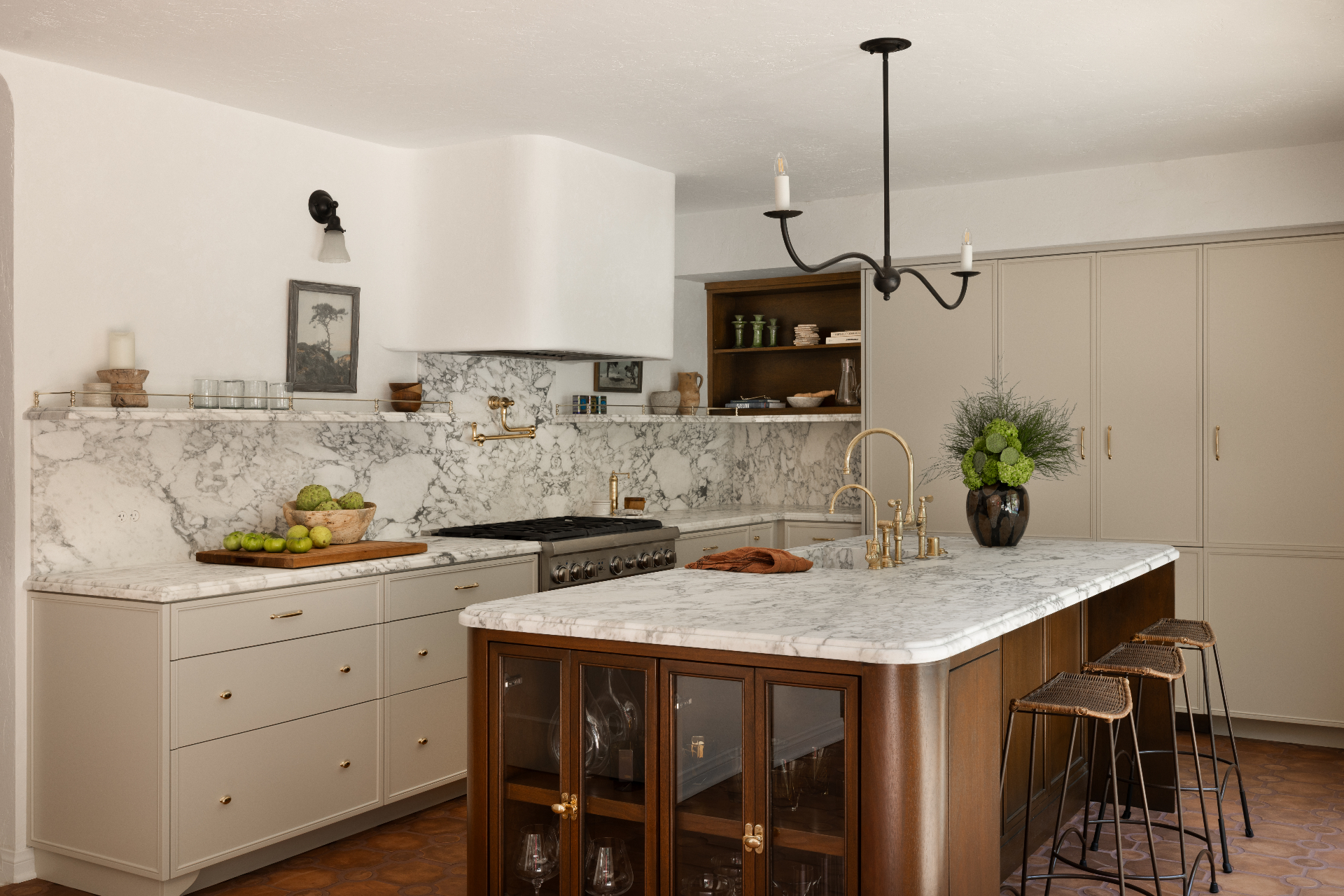 A finished kitchen with a walnut island, marble surfaces, and warm plaster walls